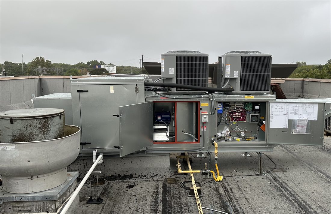 Make-up air unit opened for service by 512 Mechanical on a commercial roof in Austin, Texas