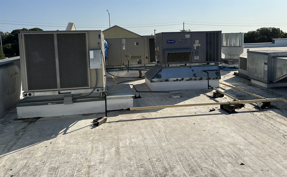 Commercial rooftop units including a Carrier packaged unit on an Austin, Texas roof